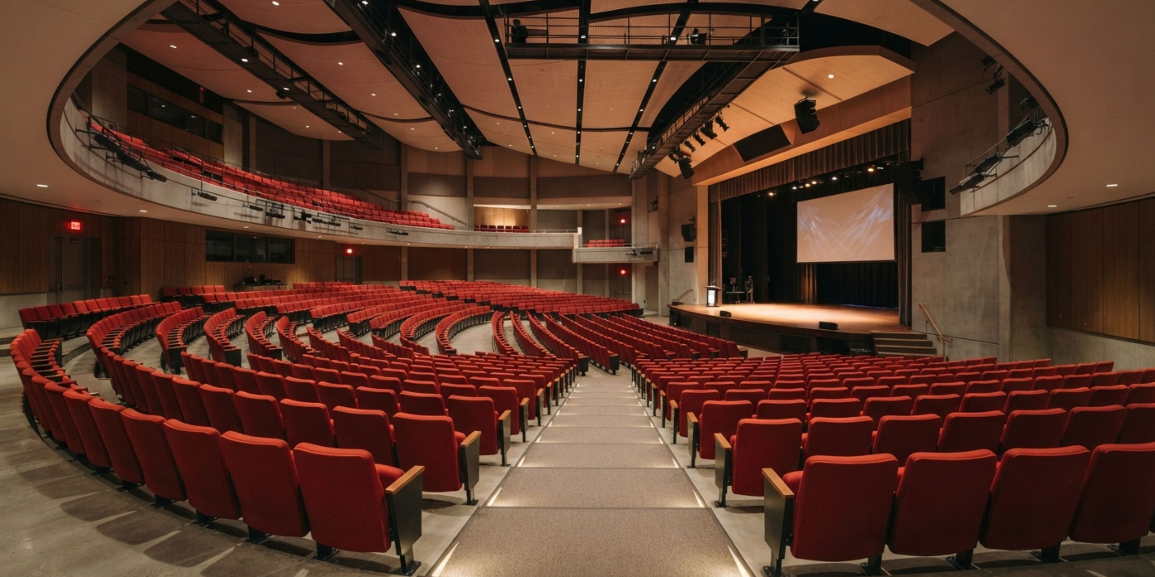 Rows of auditorium seating chairs installed in a modern auditorium hall